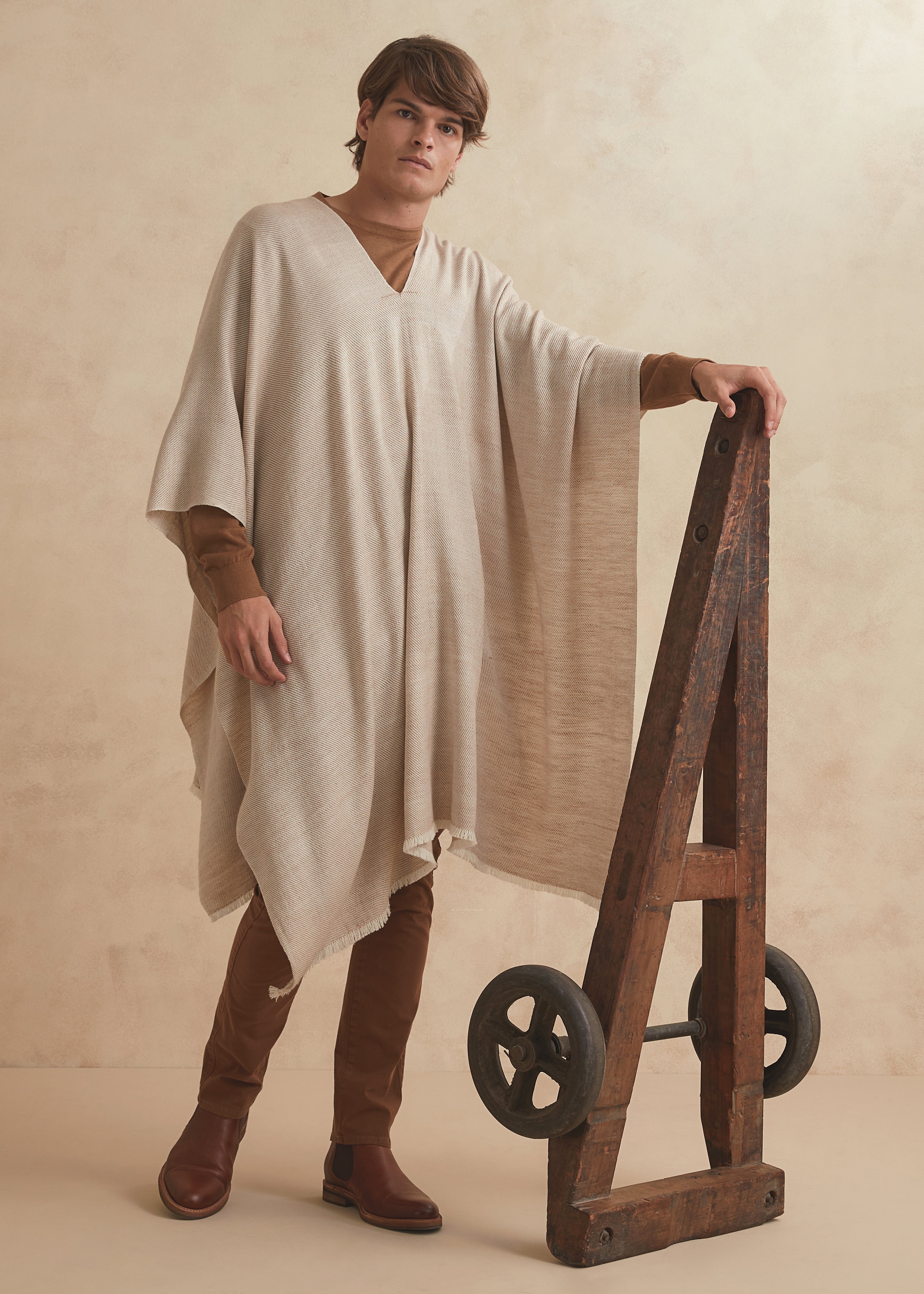 Handwoven poncho for men made of Guanaco fiber and Patagonia merino wool in natural color.