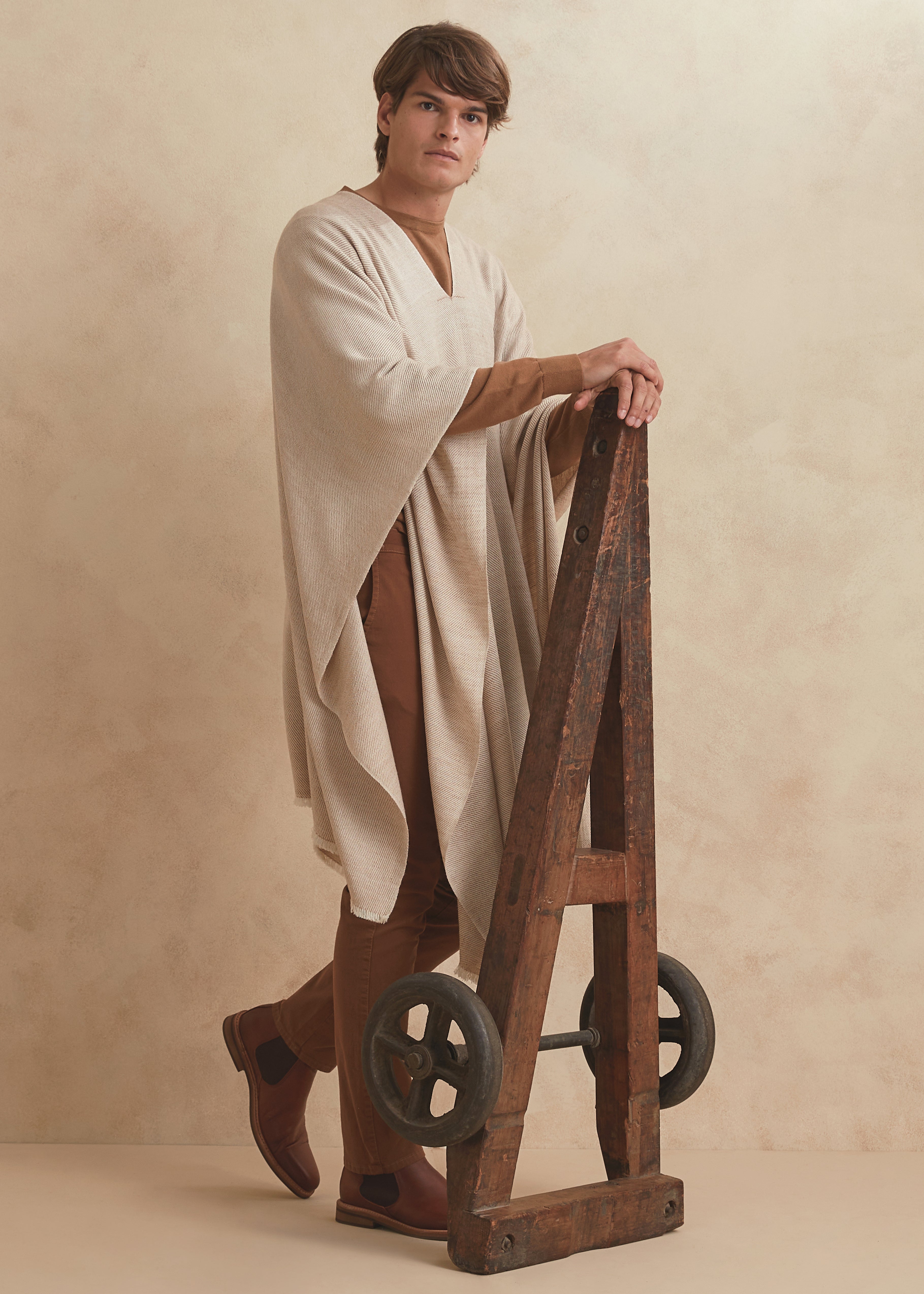 Handwoven poncho for men made of Guanaco fiber and Patagonia merino wool in natural color.