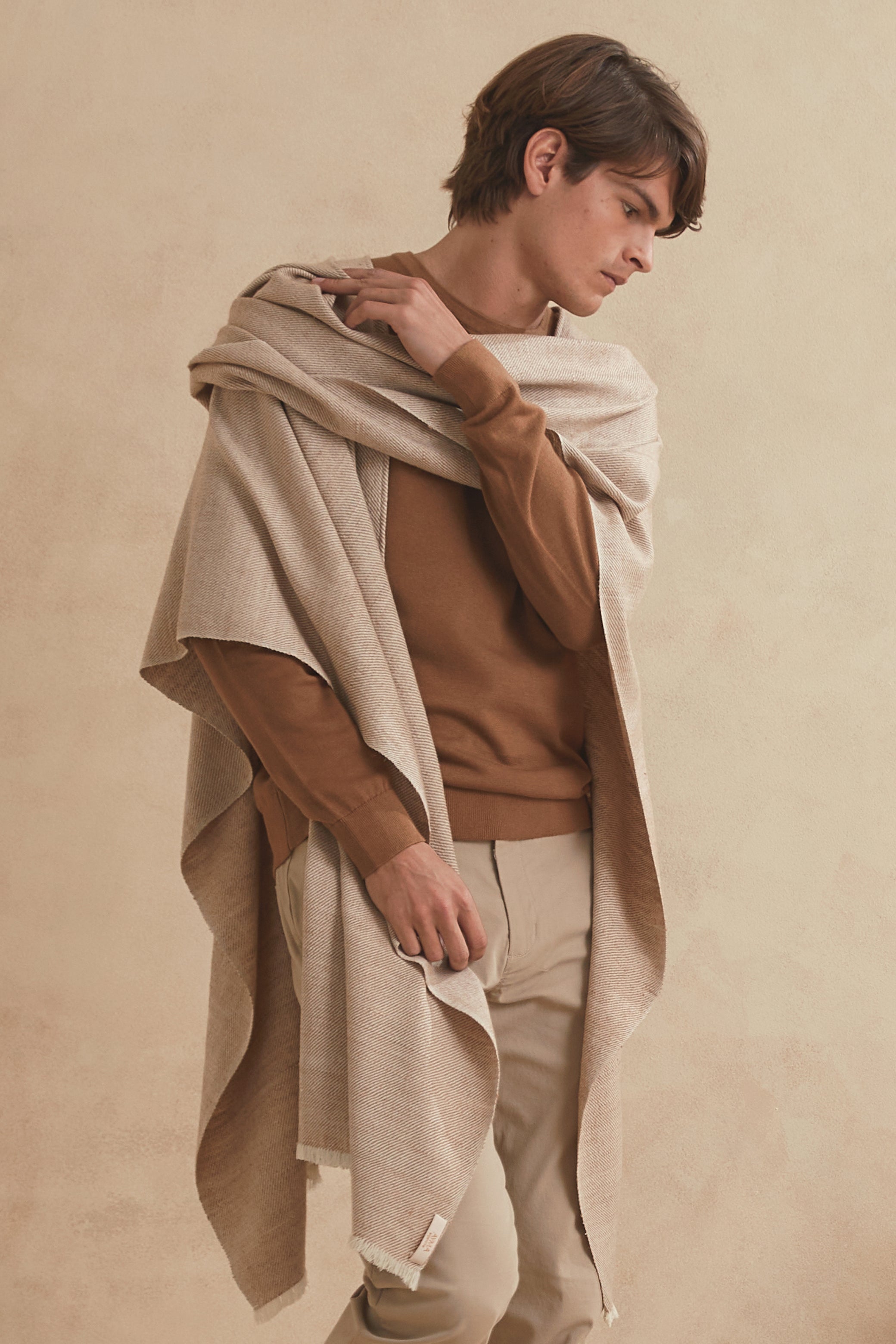 Handwoven wrap for men made of Guanaco fiber and Patagonia merino wool in natural color.